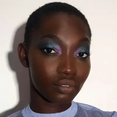 Close up of model Ndeye Arame Diaw Fall in blue and purple eyeshadow