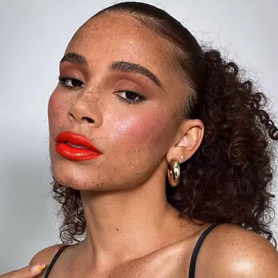 Person wearing red lipstick and eye makeup