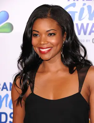 Gabrielle Union wearing red lipstick and a black dress