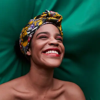portrait of smiling person on green cloth