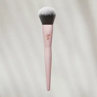 LYS makeup powder brush on textured background