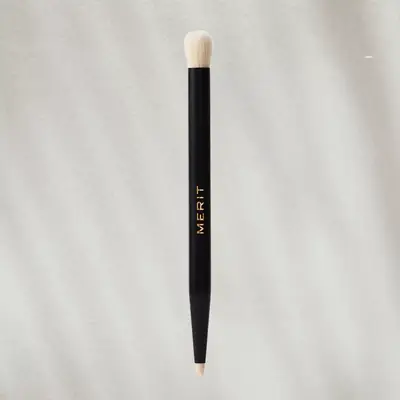 Double-Sided Eyeshadow Brush on textured background