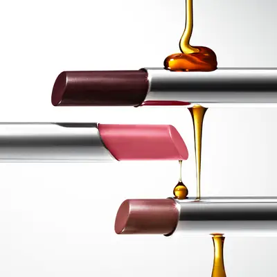 Clinique Black Honey, Pink Honey, and Nude Honey Almost Lipsticks with honey drizzled on