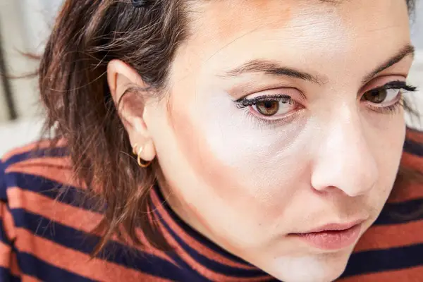 A person applies the Make Up For Ever HD Skin Cream Contour and Highlight Sculpting Palette