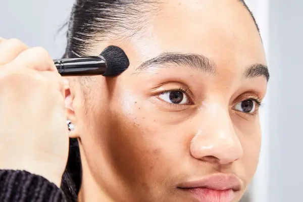 A person applies the Patrick Ta Major Sculpt Creme Contour & Powder Bronzer Duo