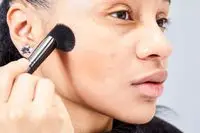 A person applies the Patrick Ta Major Sculpt Creme Contour & Powder Bronzer Duo