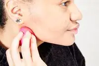 A person applies the Patrick Ta Major Sculpt Creme Contour & Powder Bronzer Duo