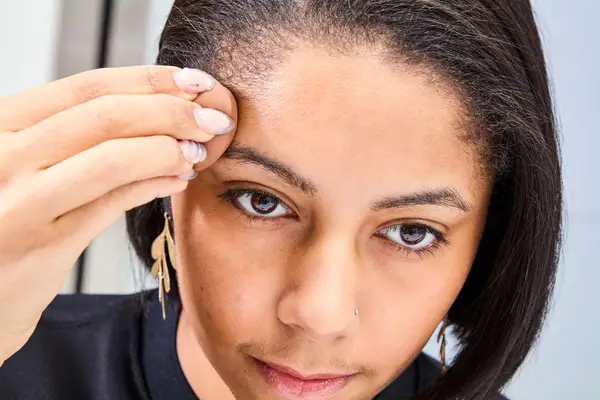 A person applies COVERGIRL Trublend Contour Palette cream with a makeup sponge
