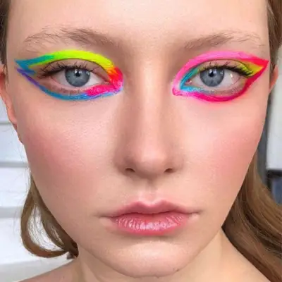 model is wearing neon rainbow eyeliner