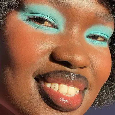 model is wearing neon blue eyeshadow