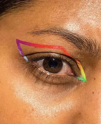 brown eye is shown wearing neon orange, yellow, green, red, purple and light blue liner composed together 
