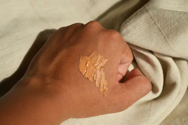 Make Up For Ever Matte Velvet Skin Full Coverage Foundation on the back of a person