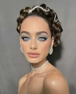 Model is wearing a variation of pastel and cobalt blue eyeshadow with prominent fluffy eyelashes