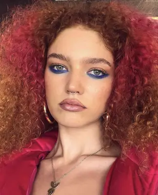 Model is wearing prominent cobalt blue liner underneath the eyes