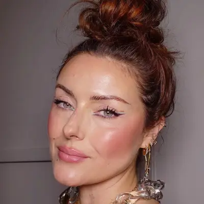 Katie Jane Hughes wears multicolored reverse cat eye makeup