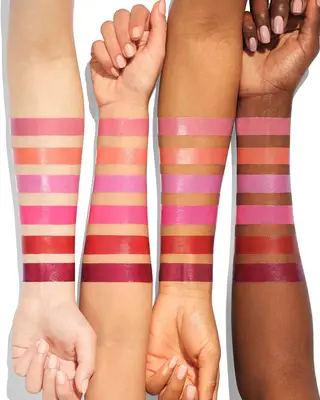 Model with long black hair and bright pink blush 