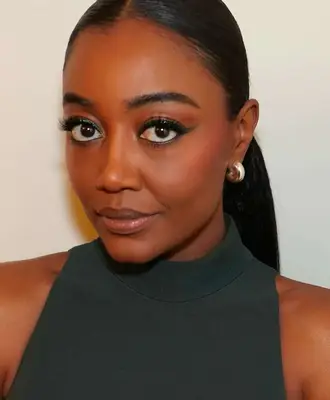 model wears winged eyeliner and nude glossy lips