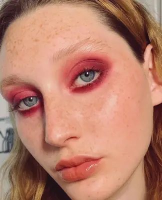 model wears cranberry red smoky eyeshadow look