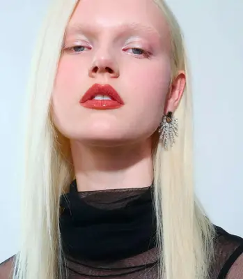 model is wearing holographic eyeshadow and red glossy lips