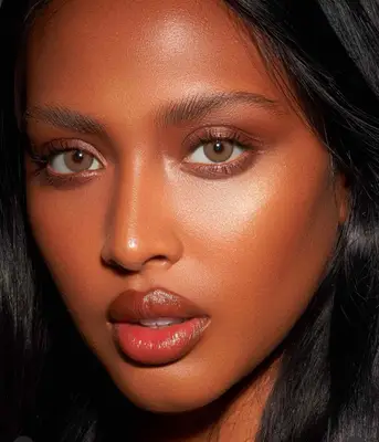 model is wearing a natural bronzed makeup look 