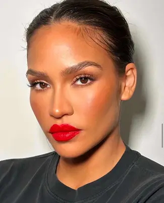 model wears bright orange red lipstick 