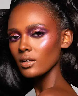 model is wearing pink and purple glitter eyeshadow