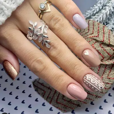 Multicolored neutral nails with heart and sweater print accents