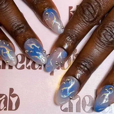 iridescent navy blue and pearl aura nails