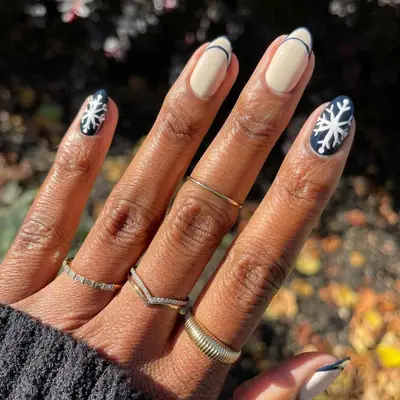 Navy nails with snowflakes and french tips