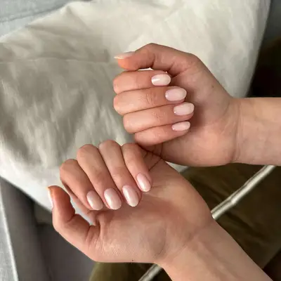 Hands with neatly sheer manicured fingernails