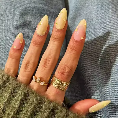 a pearlescent butter yellow manicure topped with yellow builder gel drops