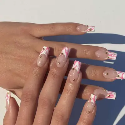 Pink and white french tips with studded accents