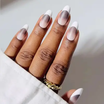 A manicure with an ombre base and white french tips