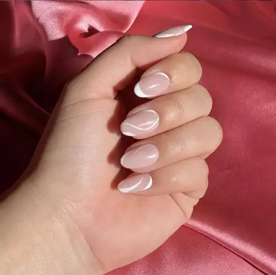 A manicure with white swirls and French tips