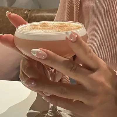 A white French manicure with pearl accents