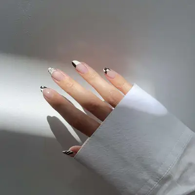 A black and white mismatched manicure