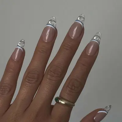 A French manicure with white, blue, and clear tips