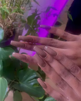 A glossy brown manicure. 