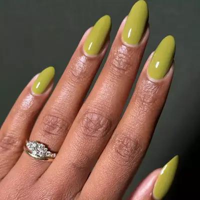 close up of nails painted in olive green shade