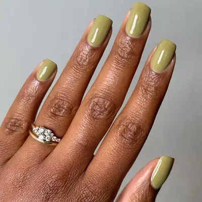 close up of nails painted in olive green shade