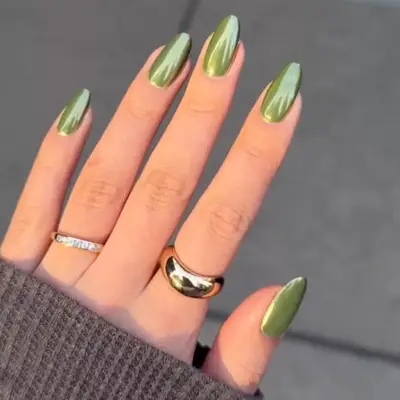 close up of nails painted in olive green chrome shade