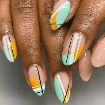 blobs of minty green nail polish in an abstract manicure design