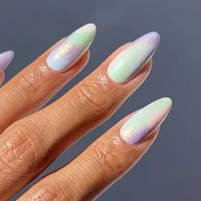 an ombre manicure in green, blue,and purple