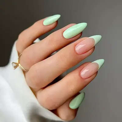 a mint green manicure with a mix of french tips and solid fingers