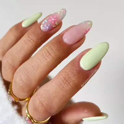 a manicure with solid mint tips and floral accent nails