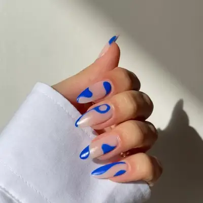 royal blue almond shaped nails long with lots of negative space abstract design