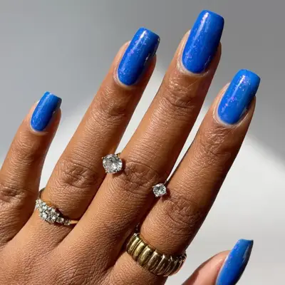 square shaped nails with hints of glitter and subtle lighter shade of blue at french tip
