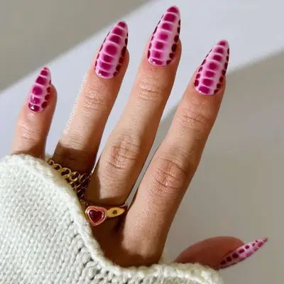 Berry-colored snake print manicure.