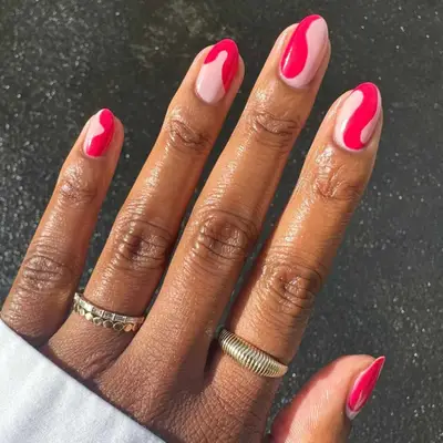 Manicure with pink-tinged berry-colored swirls.