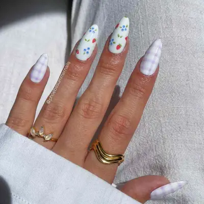Lavender-striped manicure with strawberries and bluberries on two accent nails